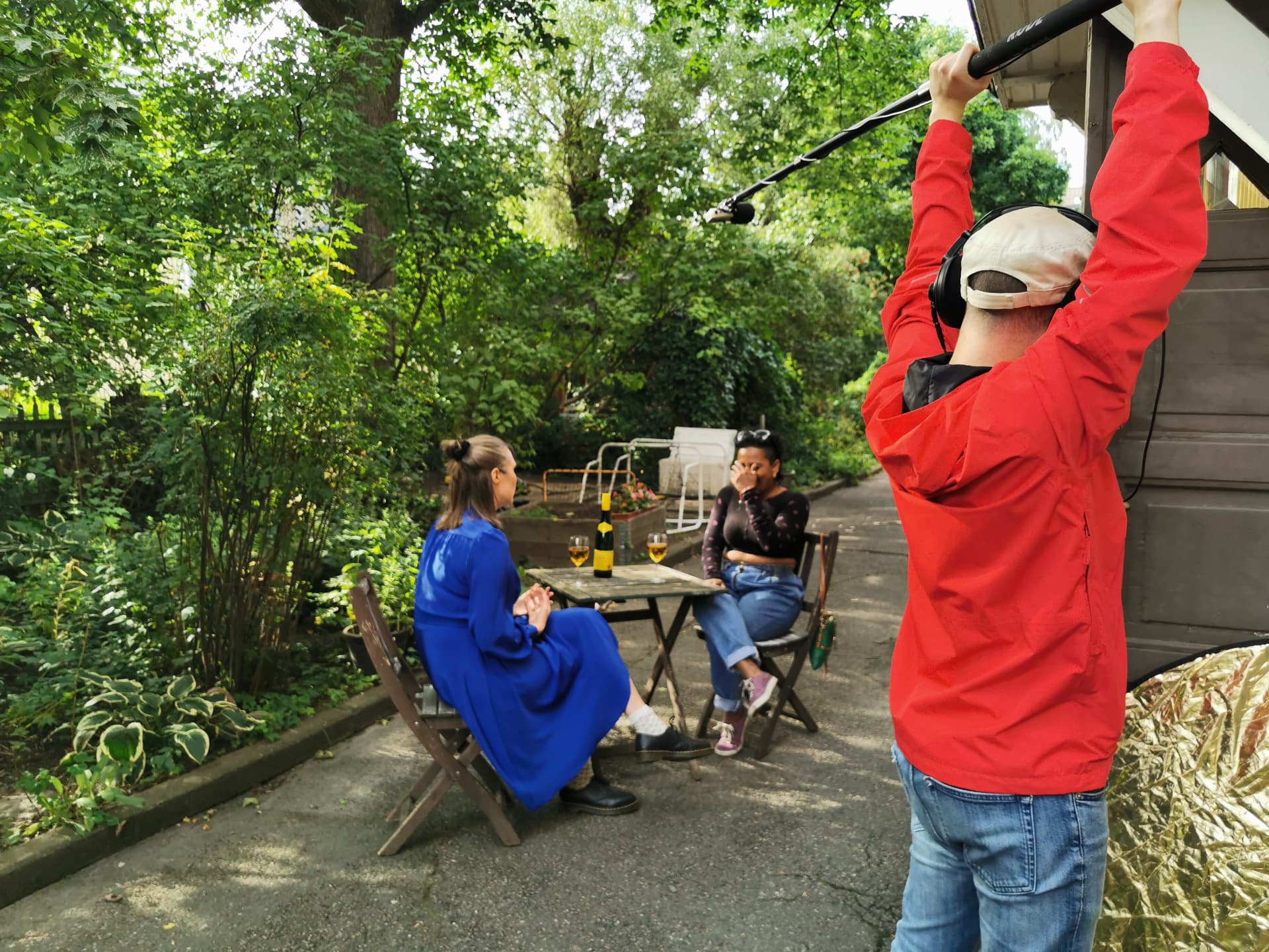Sound recordist booming the courtyard conversation scene