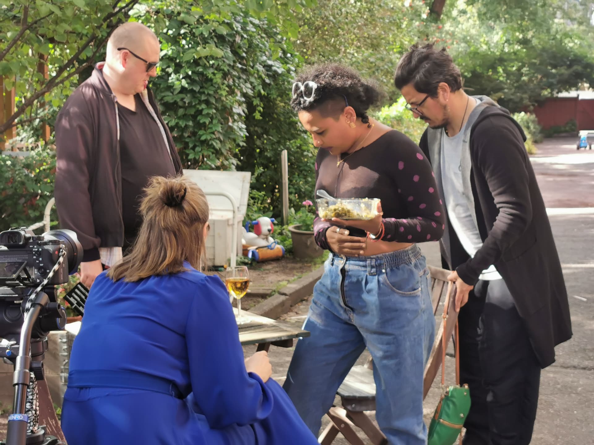 Crew and performers looking over a scene in the courtyard