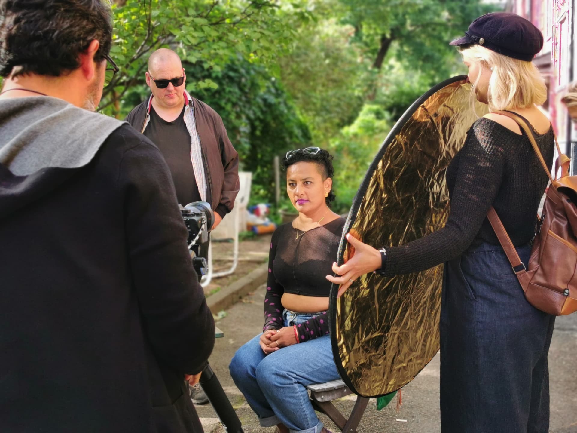 Crew adjusting the reflector before a take